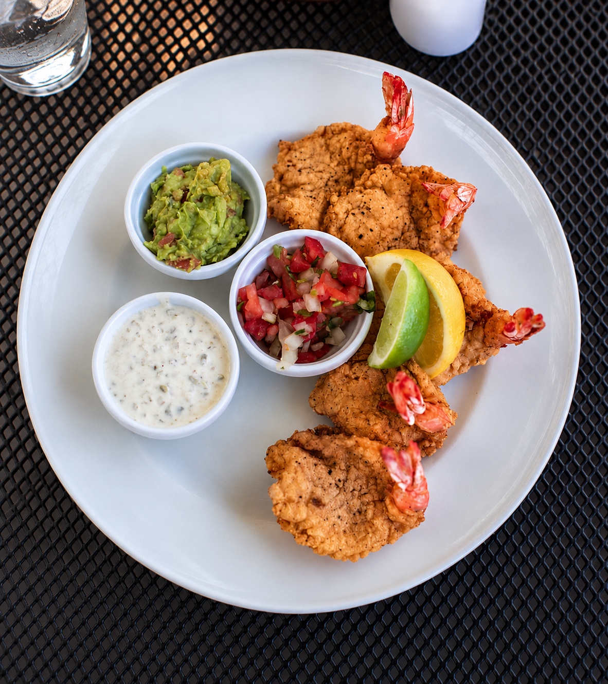 Battered fried Gulf shrimp with guacamole, salsa fresca and poblano-chile crema, with lemon and lime