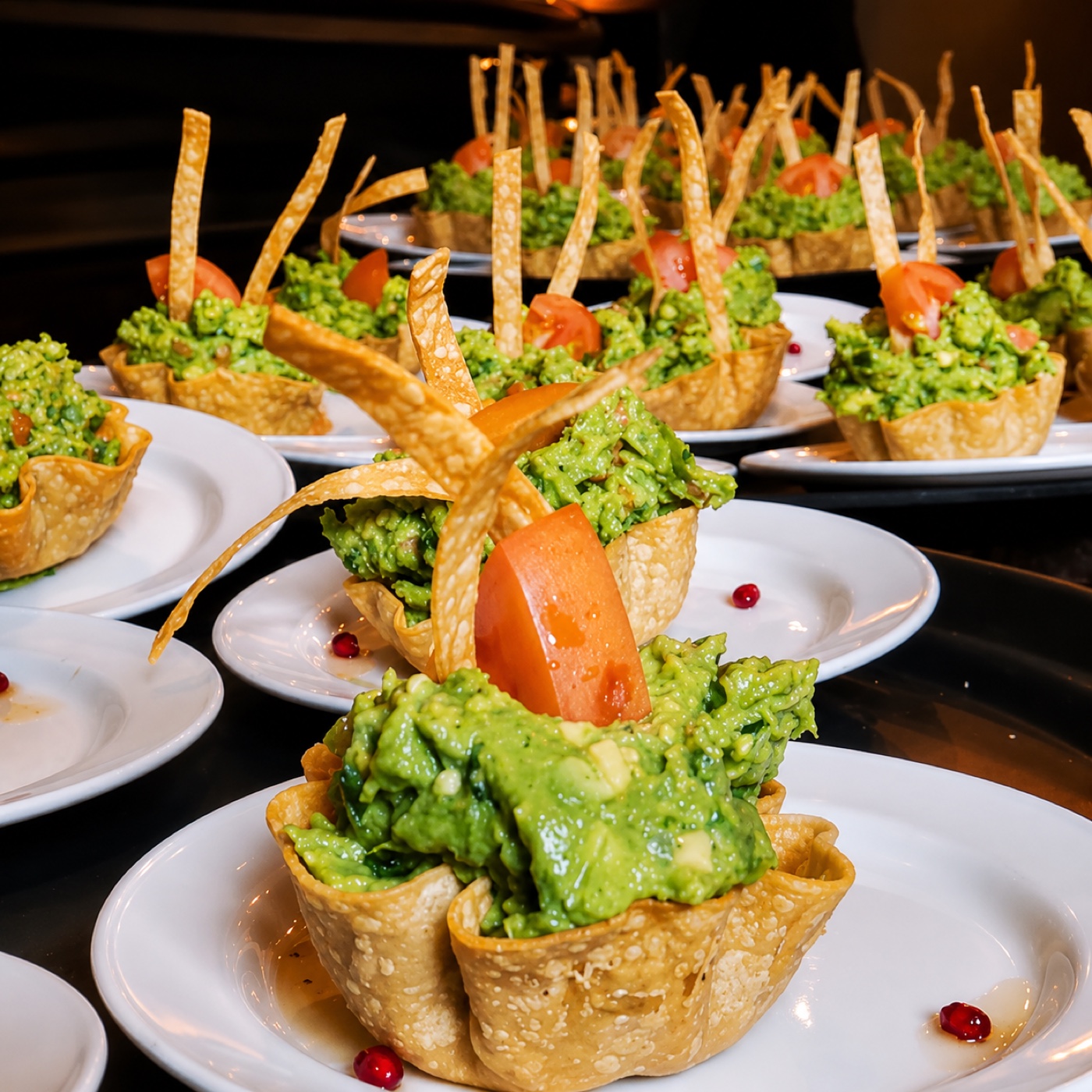 Guacamole served in crisp tortilla cups topped with tomato and fried tortilla strips